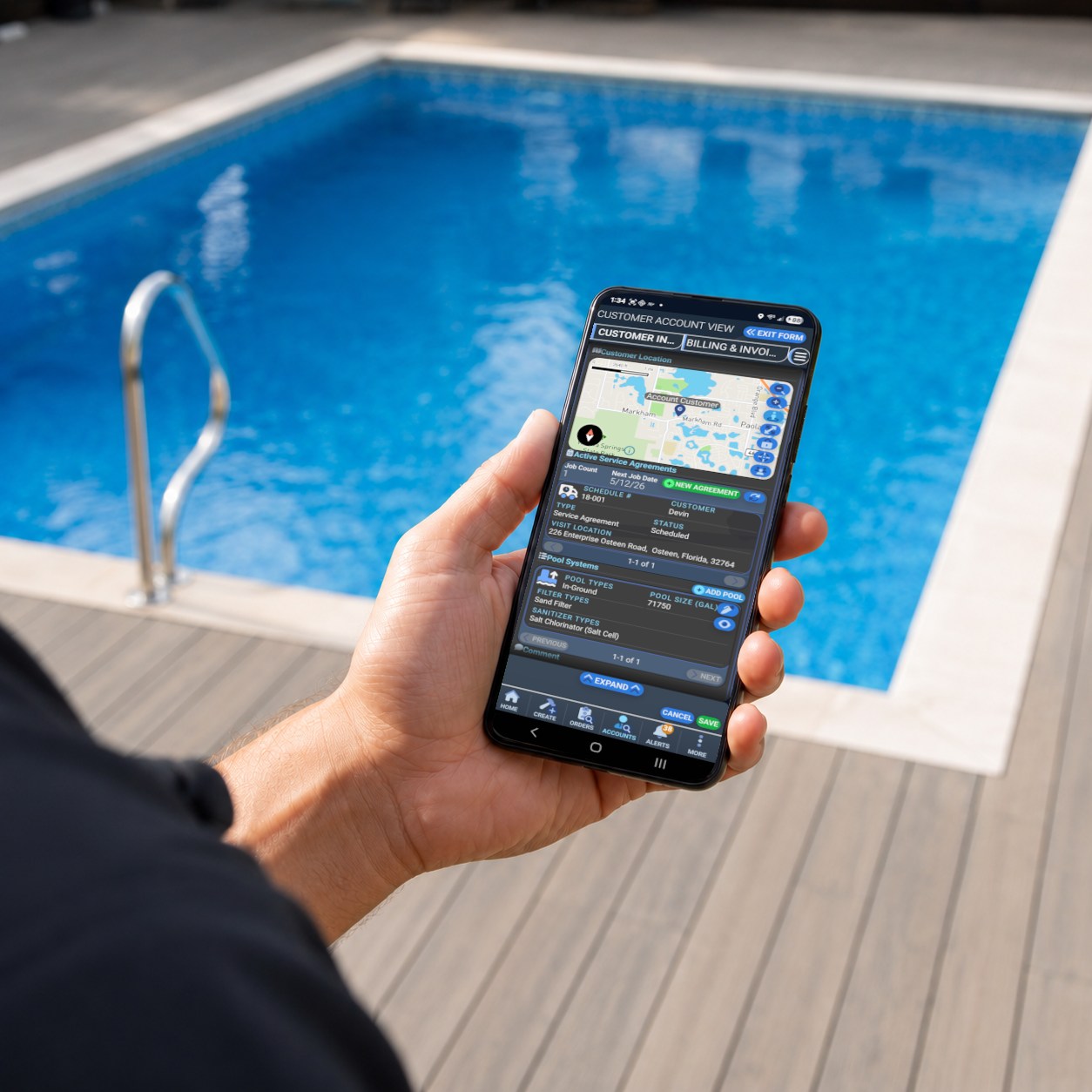 A technician by a pool using a phone with the FlowForge Pool app